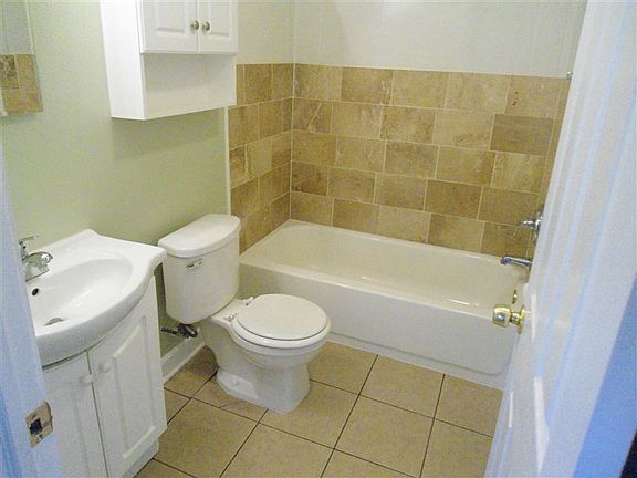 Updated bath room ceramic surround and flooring, newer vanit