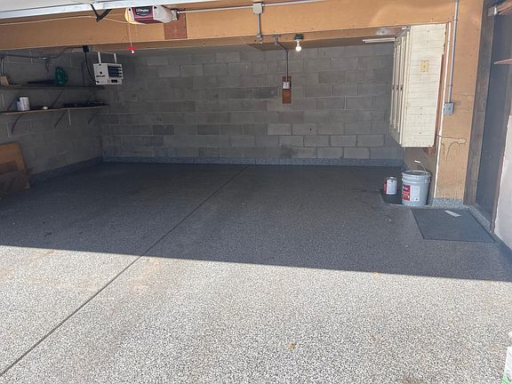 Heated Garage w/ Epoxy Flooring and lots of storage.