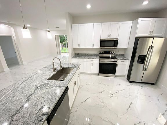 New granite countertops, cabinets, stainless steel appliances, and lighting features throughout. New appliances. New indoor washer and dryer (not in garage).