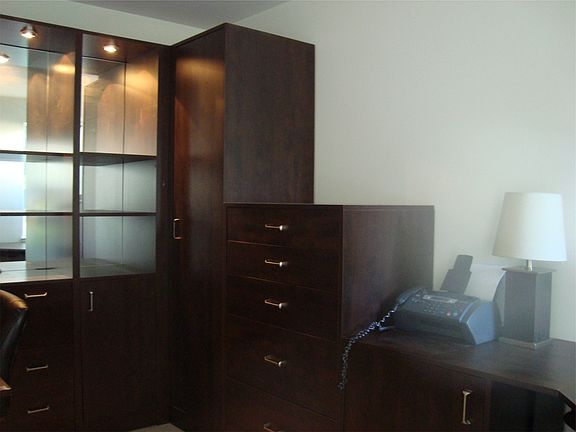 Rich built-ins offer closet and drawers for storage