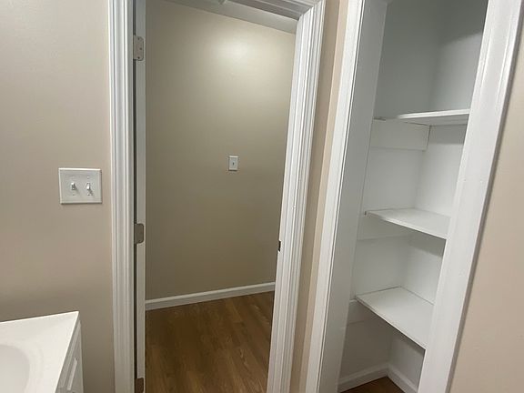 Beautifully refurbished bathroom featuring a stylish grey granite backsplash, modern fixtures, and sleek tiling throughout. The updated design combines elegance and functionality, creating a fresh and contemporary feel.