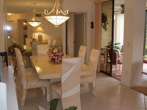 Dining room has a decorator mirrored wall which opens the room
