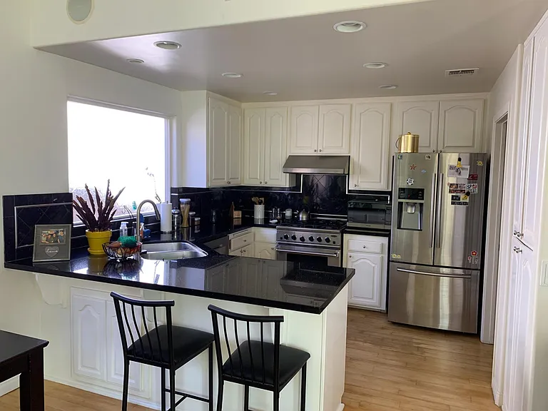 View of the kitchen. Big windows downstairs give a bright and airy feeling all day. Laundry room is just off the kitchen.