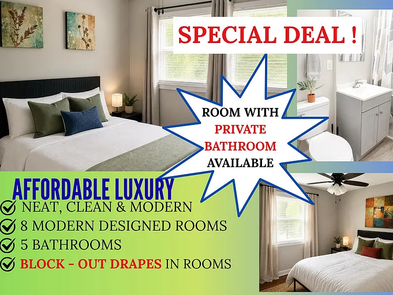 Furnished bedroom with a full-size bed, nightstand lighting, and window with drapes, plus access to a private bathroom.