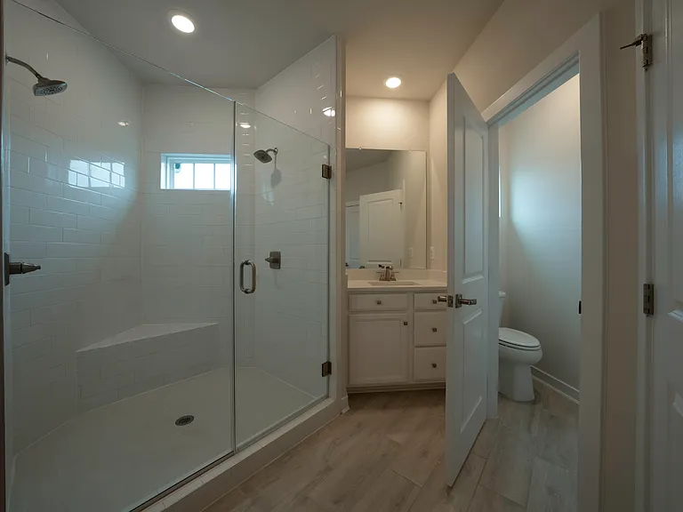 Owner's Bathroom features his and her vanities and Roman shower with dual shower heads