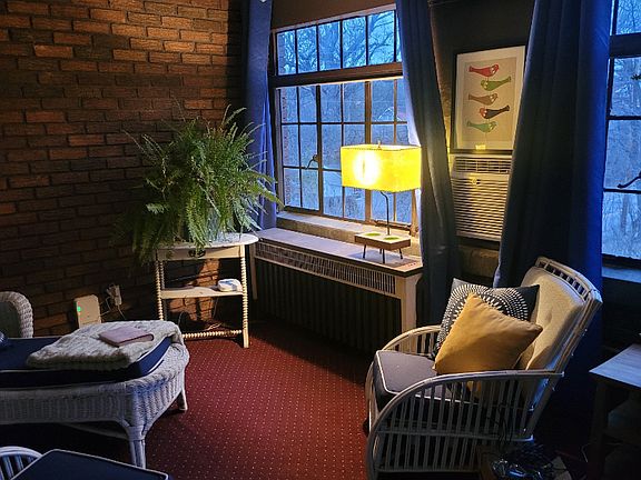 Large, cozy sunroom for morning coffee or convenient home office.