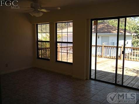 FAMILY ROOM LOOKING OUT AT DECK AND DETACHED GA