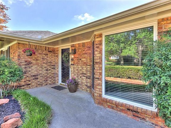 Entry walk way, with established flower beds, mature shrubs, hostas, elephant ears, lantana and rocks hand selected, one-by-one, from varying parts of Oklahoma. A few sentimental ones are reserved but most will remain.