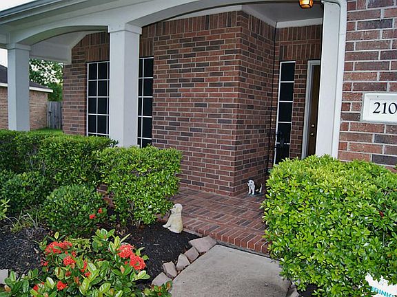 FRONT PROCH ENTRY WITH MATURE LANDSCAPING