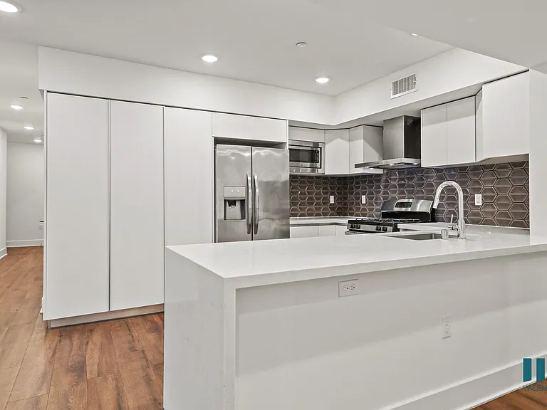 Kitchen with Pantry Cabinet Storage and Stainless-Steel Appliances