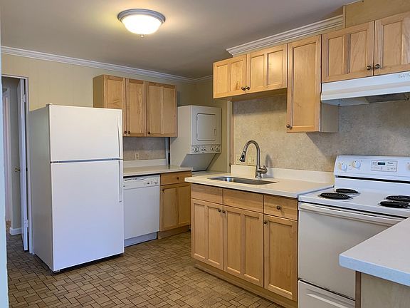 Updated kitchen with Maple cabinets, quartz counter tops, undermount sink, dishwasher and tile floor.