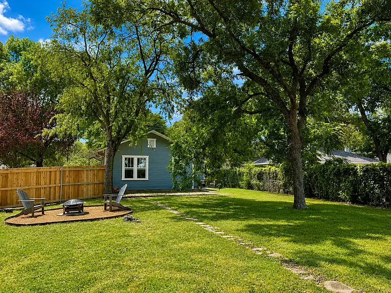 Massive, fully fenced backyard with a private patio, cozy fire pit, and plenty of room to relax, play, or enjoy time with your pet.