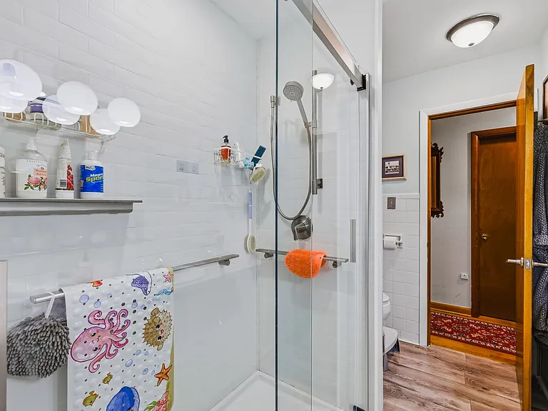 MAIN LEVEL Full Bath with Walk-in Shower (Double Sinks and Vanity behind camera, Hall ahead)