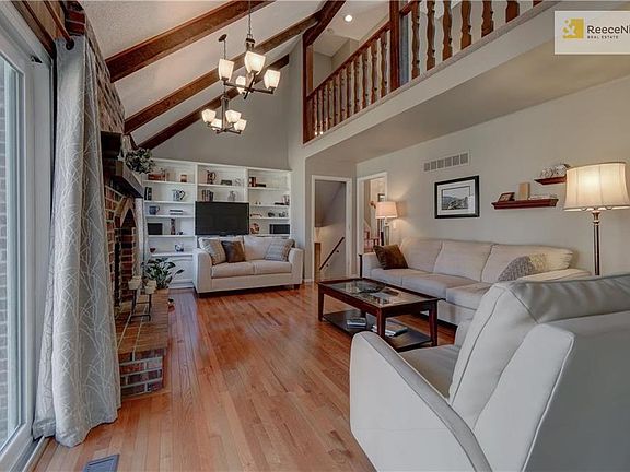 Loft overlooks Family Room Fireplace and Wood Beams