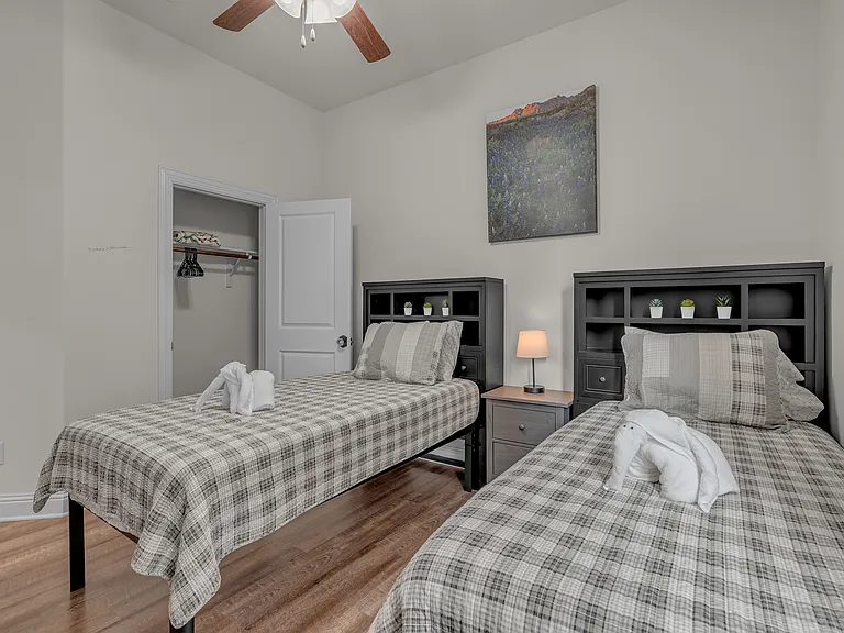 3rd guest bedroom with two twin beds, side table, lamp, ceiling fan, closet and dresser (not pictured)
