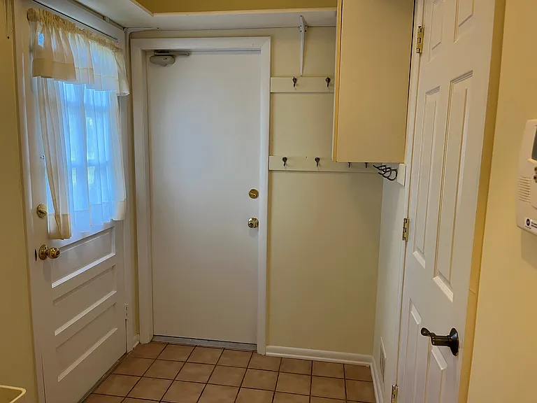 Mudroom with door to garage and door to side yard