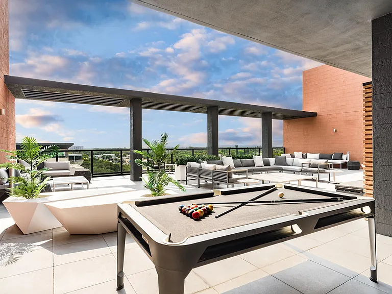 Sky lounge with billiards, sectional seating, and open-air views, creating a versatile setting for games, gatherings, and sunset conversations.
