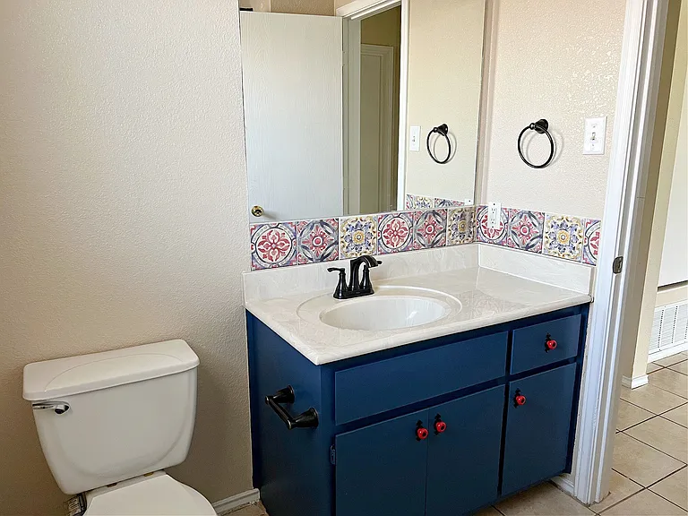Hall bathroom sink and cabinets.