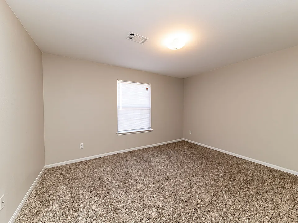 Cozy bedroom with carpet & overhead lighting
