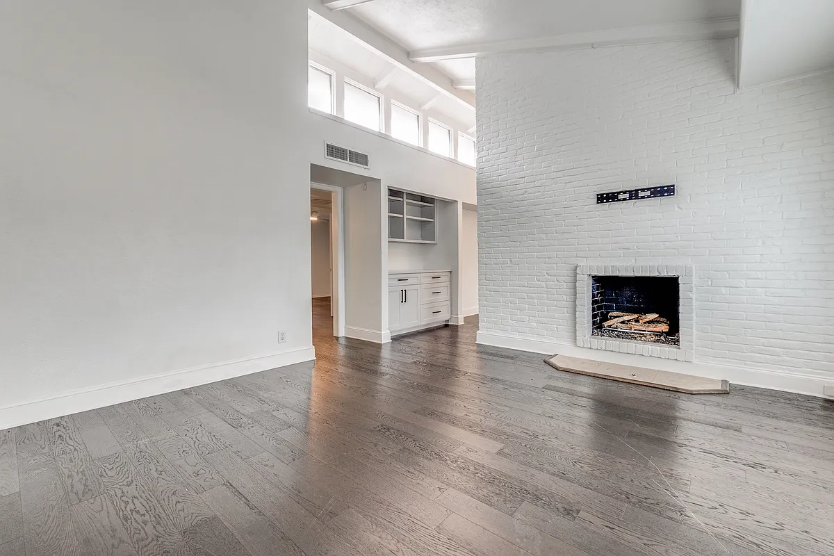 This is the other view of the living area with the renovated bookshelf and cabinet area in the area as well! - 5930 Sandhurst Ln #214