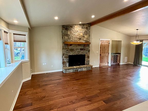 Living room with bay window, gas fireplace, engineered hardwood floors