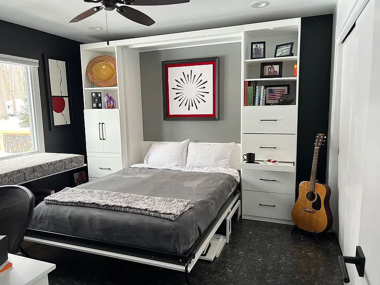 office desk folds down into queen-size bed with stay-level desk below; left cabinet holds pull-out drawer with printer