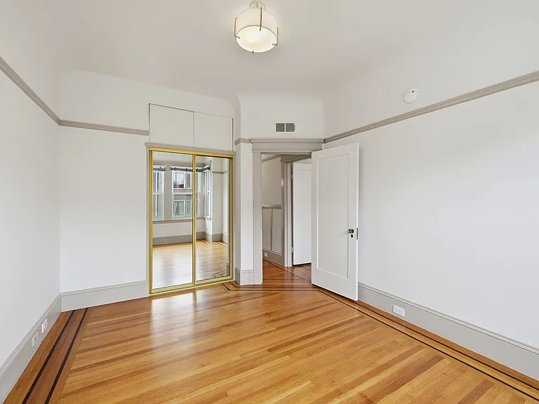 Alternate view of the 2nd bedroom, from the window facing towards the door/ hall.