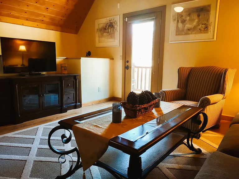 Guest House Living Room: Spacious & Cozy Living Room with Queen Size Pull Out Sofa, Queen Anne Chair, Large Screen TV & Enjoy the Morning Sunshine on Balcony with Table & Chairs