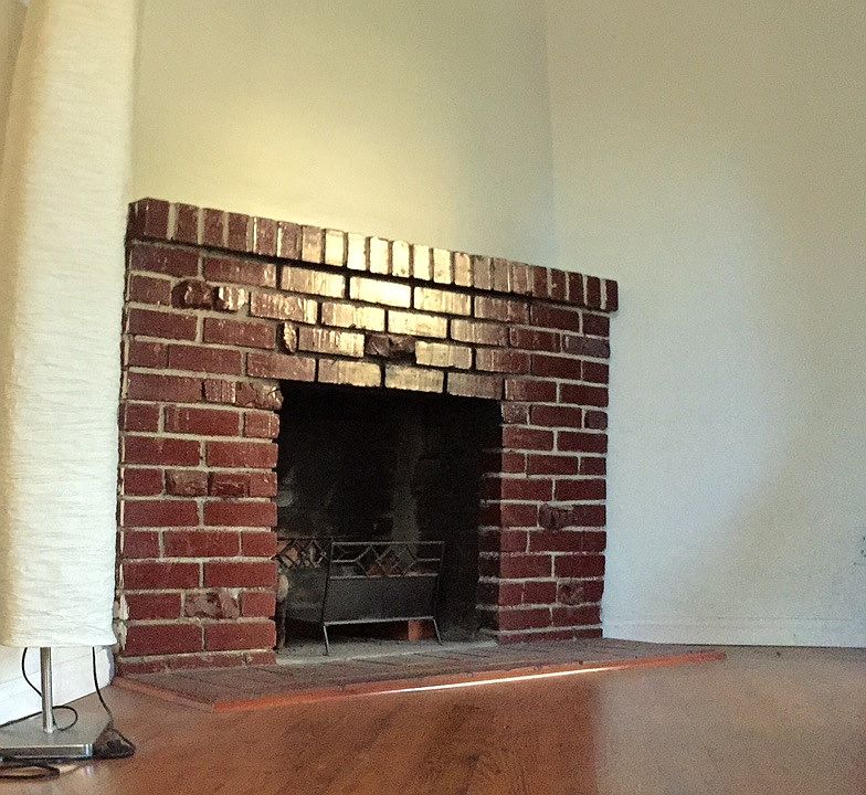 Beautiful natural brick fireplace with hardwood floors!