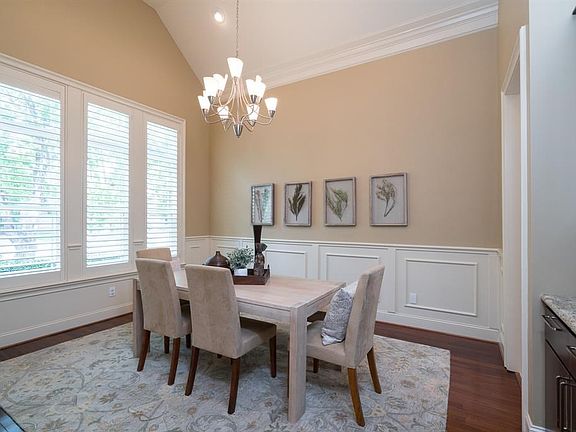 Formal dining with high ceilings, and rich base boards with wainscoting, and double crown molding.   Wood cabinets and granite counter along with glass uppers appoint the butler's pantry.   Great to display fine china or serve dinner for family and friend
