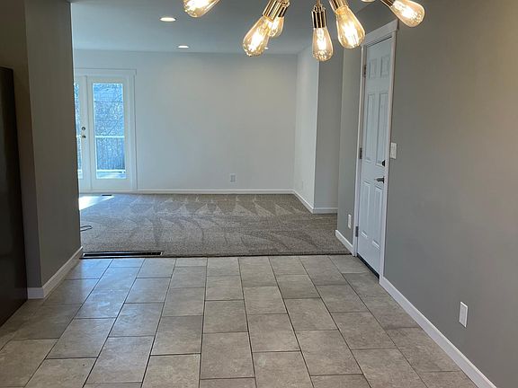 Large dining room. Tiled floor, opens into living room.