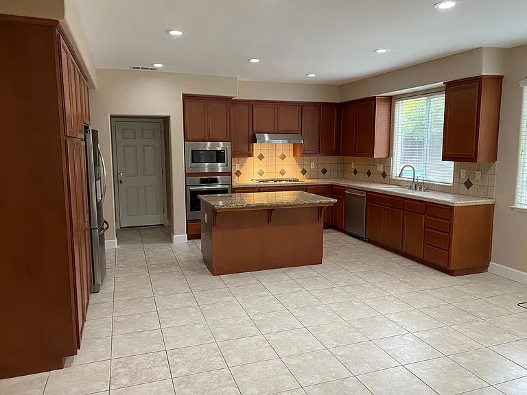 Kitchen includes new appliances including a Wolf cooktop.