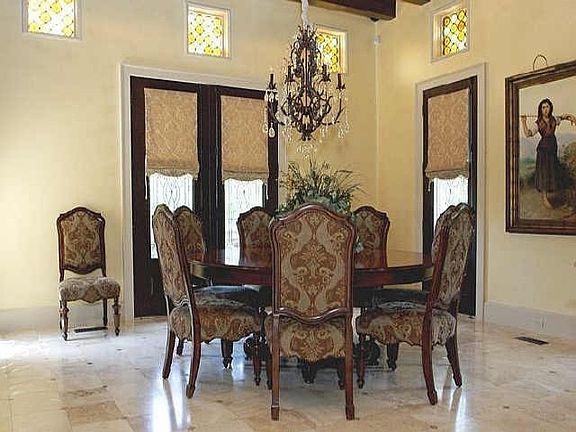 Elegant formal dining room with travertine floor