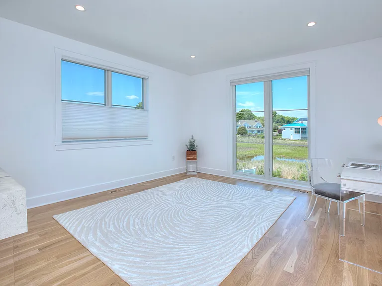 First floor bedroom suite, thoughtfully furnished as a private home office overlooking the peaceful marshlands.