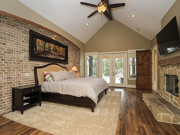 Master bedroom with vaulted ceilings and french doors to back covered patio