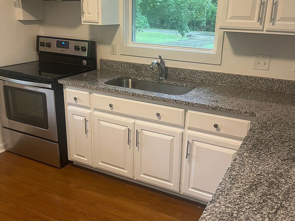 Very clean kitchen includes lots of cabinet space, granite countertops, refrigerator, stove, dishwasher