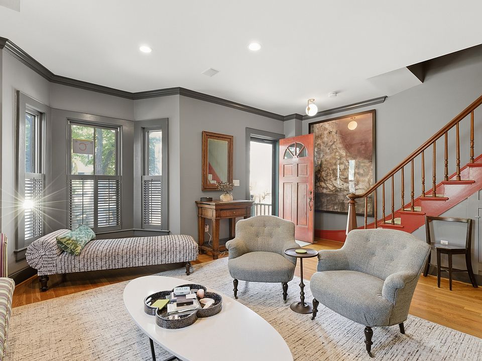Living room with bow window, period details.