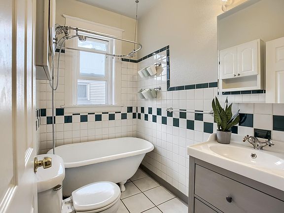 Light and bright bathroom combines thoughtful storage with old-world charm