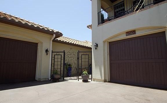 Front upstairs patio captures the breeze and Hill Country views.  Home invites you with a gated private patio with water fountain.