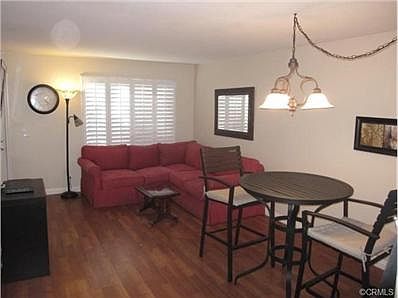 Spacious light & bright living room with plantation shutters & l