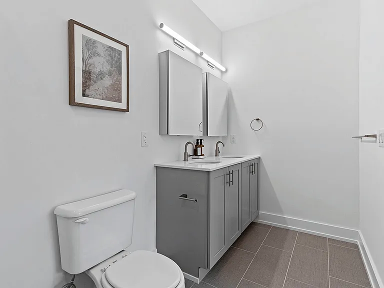 Experience tranquility in this stylishly designed bathroom, featuring modern amenities and elegant fixtures.