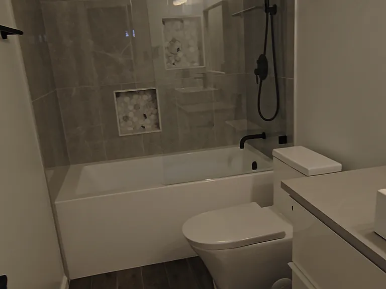 Bathroom 2 with soaking tub, ADA/comfort height toilet, rainfall shower with handheld