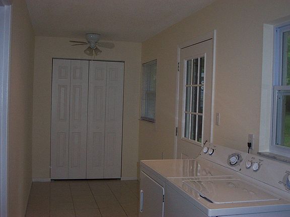 Laundry room with huge closet and back door to deck