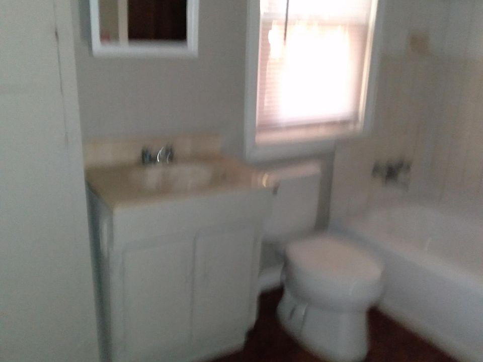 Bathroom with cabinet sink and tub/shower
