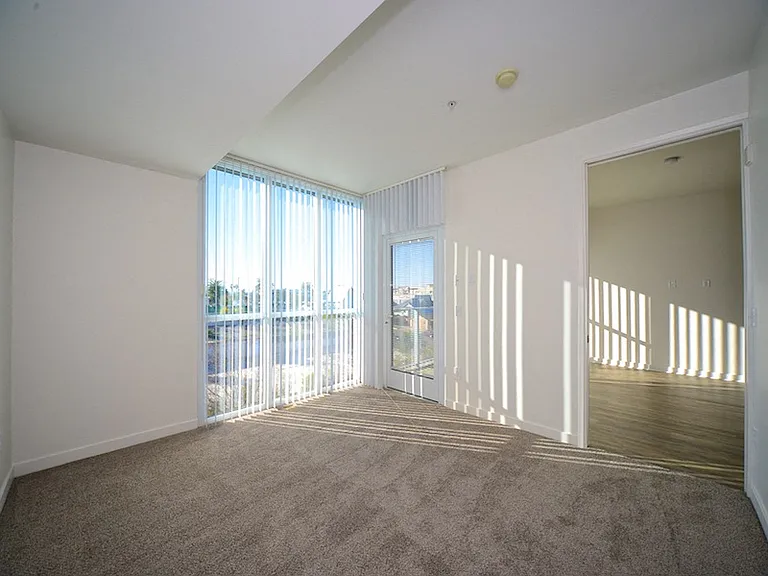 Master bedroom with carpet and fantastic light and views at 12th Street Lofts in National City, California.