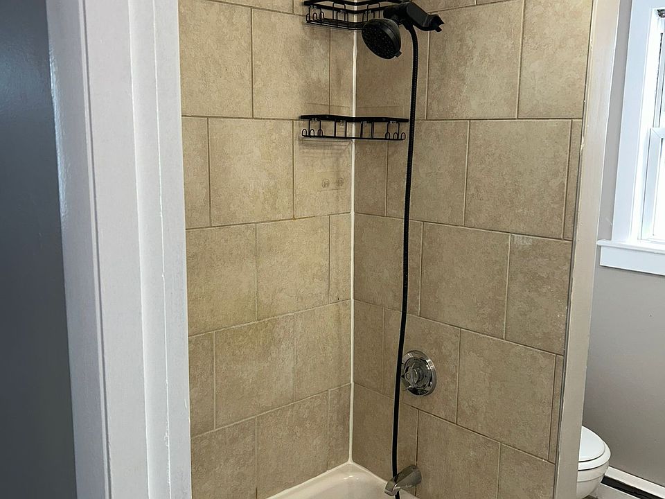 bathroom with new shower head and extended wand