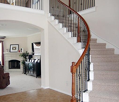 Gorgeous two story open entry with dramatic curved wrought iron stair rail.