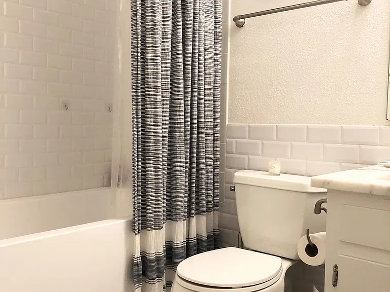 This is the full bathroom. It was remodeled in 2020 and has a large deep bathtub, new fixtures and a marble counter top.