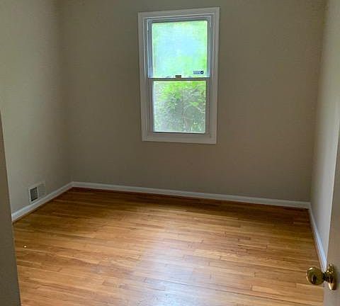 Second bedroom with view of front yard (shrubbery for privacy).