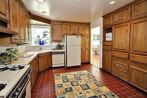 Spacious kitchen with garden windows and cabinets galore
